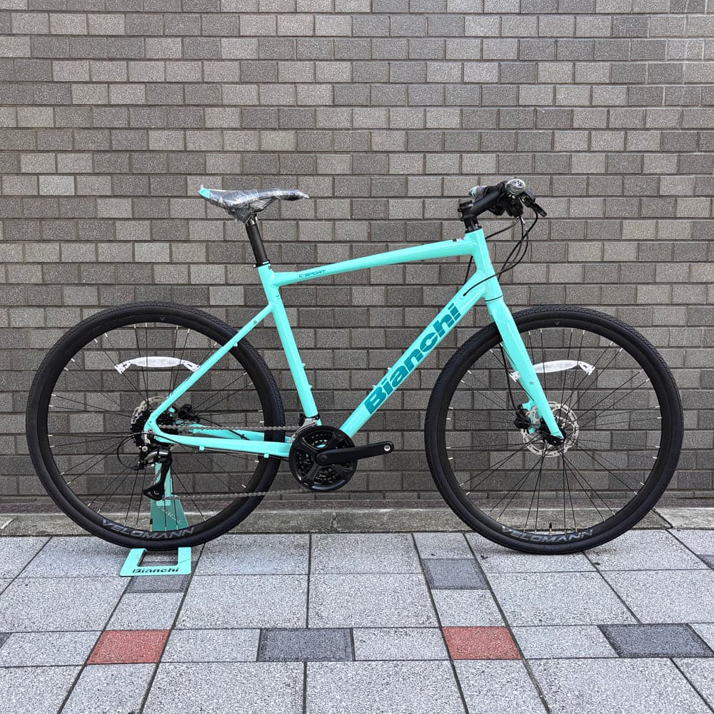 販売店Web掲載のチェレステ水色のビアンキ C-SPORT 2。フラットハンドルとディスクブレーキを備えた車体